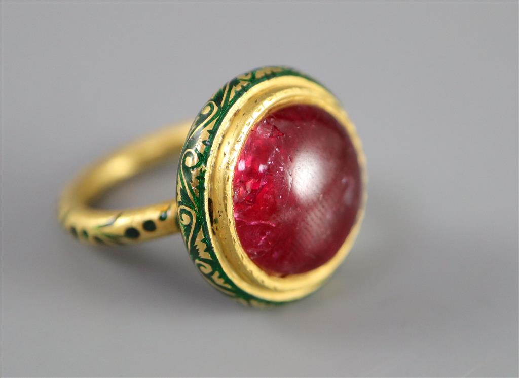 An antique Mogul gold, green enamel and cabochon natural red spinel set ring, size K.